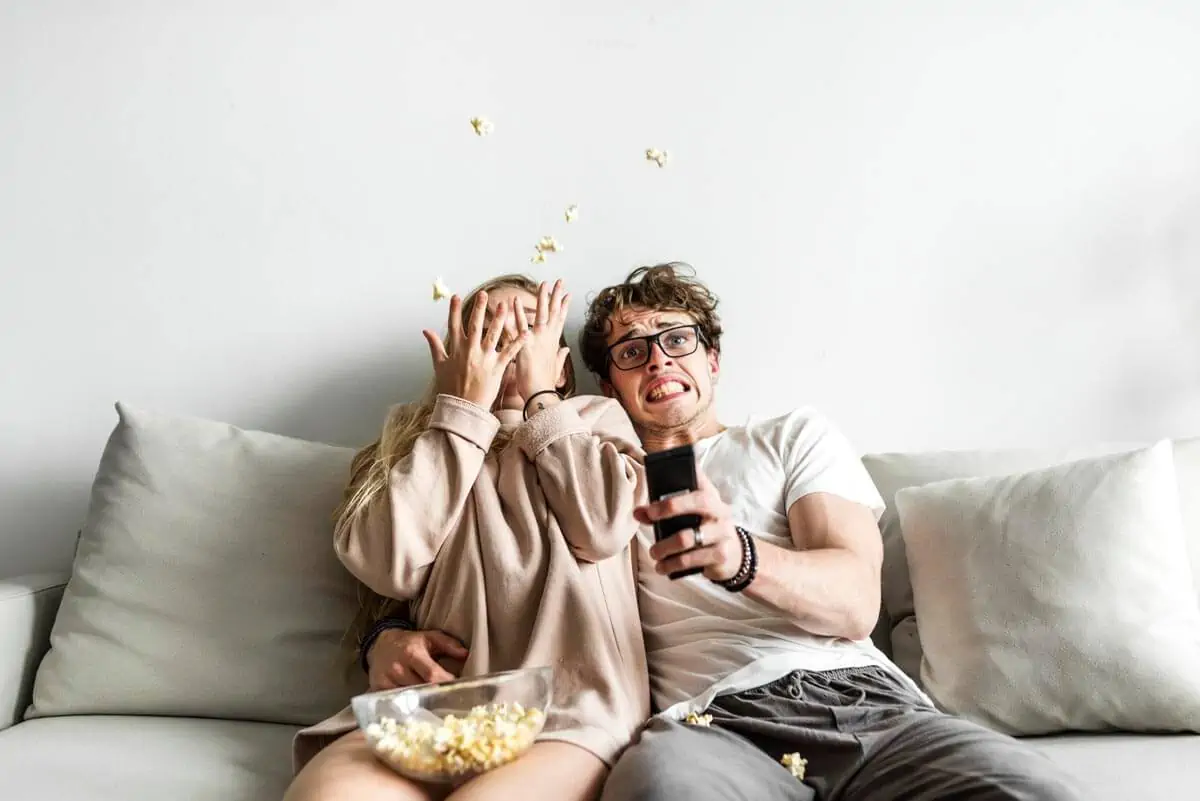 Couple watching movie at home together