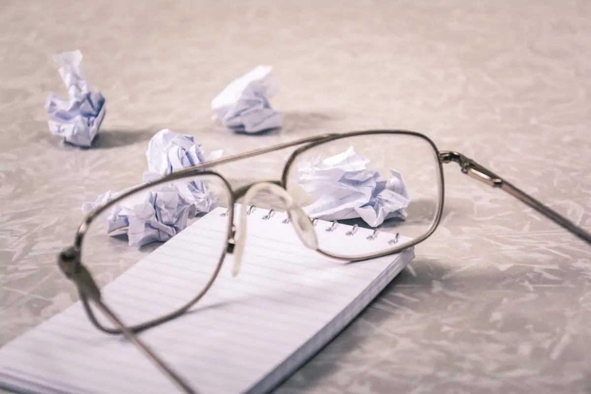 Eyeglasses Near Crumpled Papers