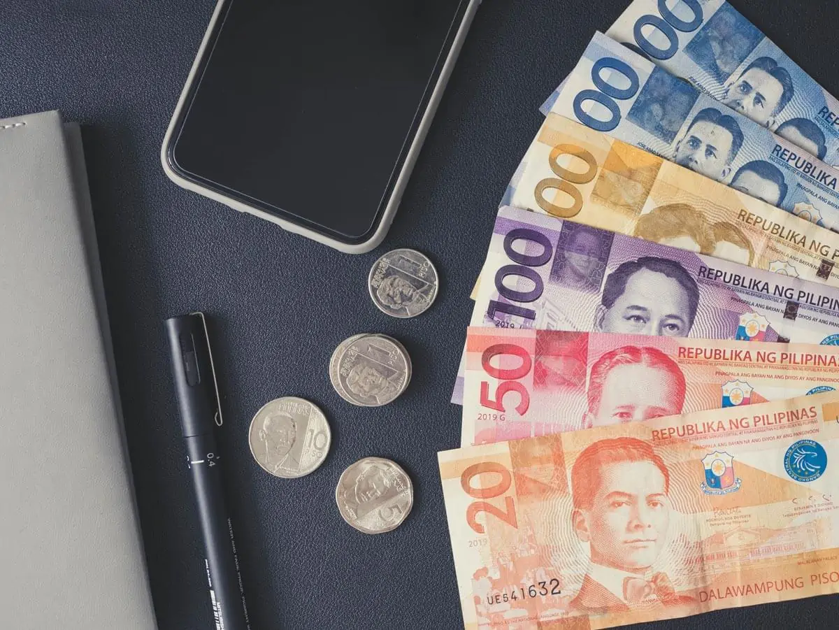 philippine money on a black surface