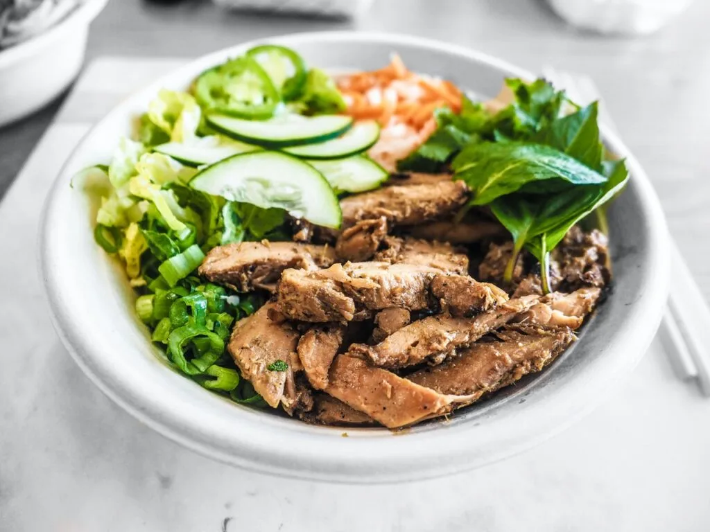 bowl of sliced vegetables and meat