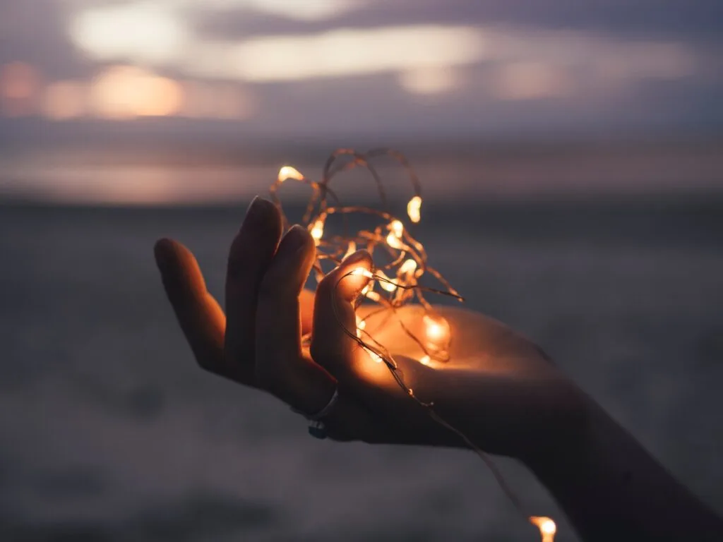 hand holding christmas lights