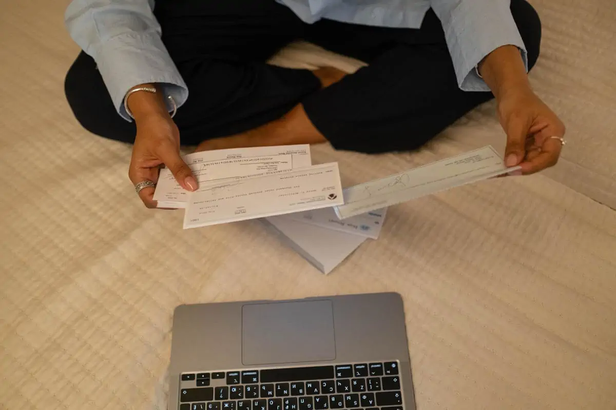 Photo of a Person's Hands Holding Cheques