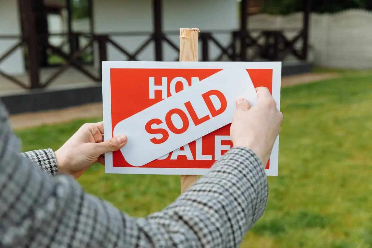 Photo of a Realtor Posting a Sold Sticker