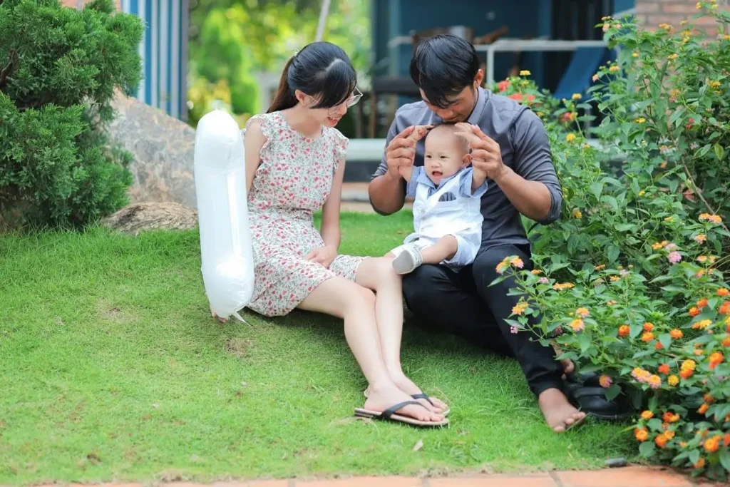 a couple and their child spending leisure time in the garden