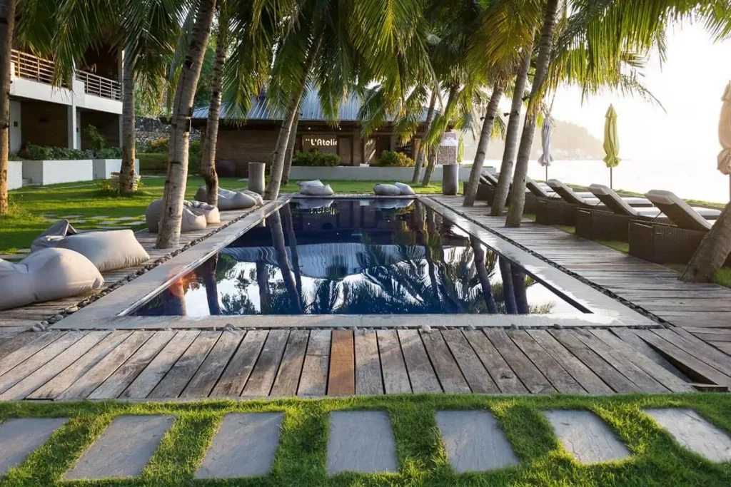 minimalist pool surrounded by coconut trees