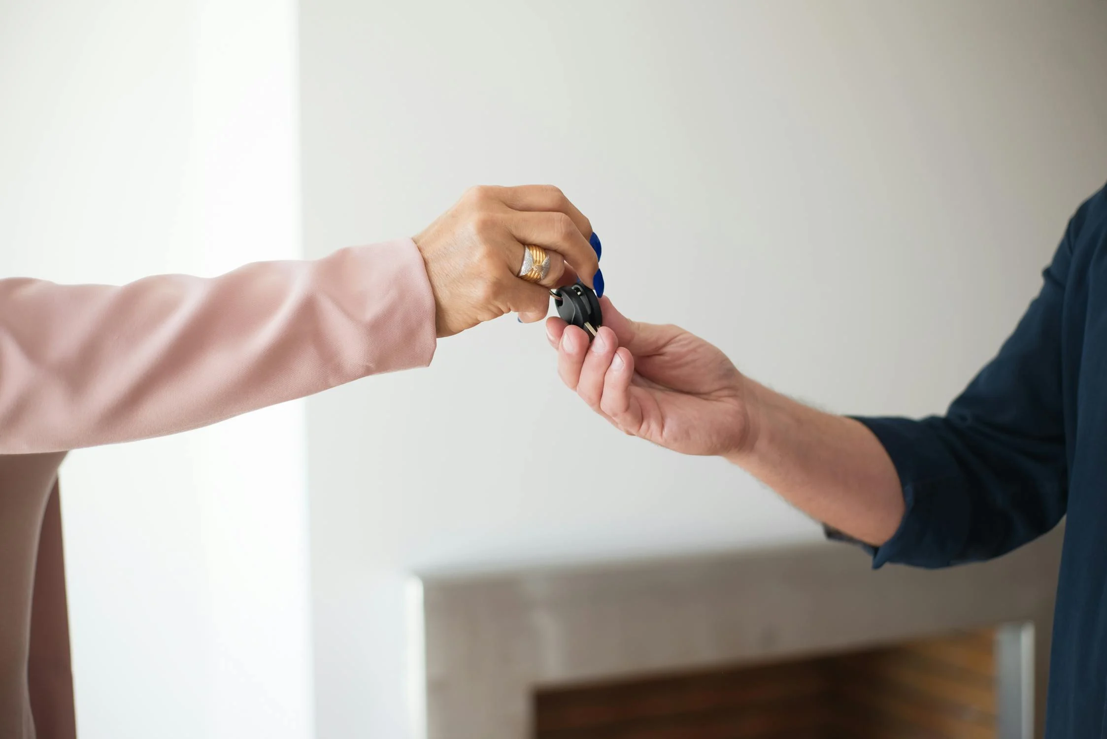 person giving keys to another person