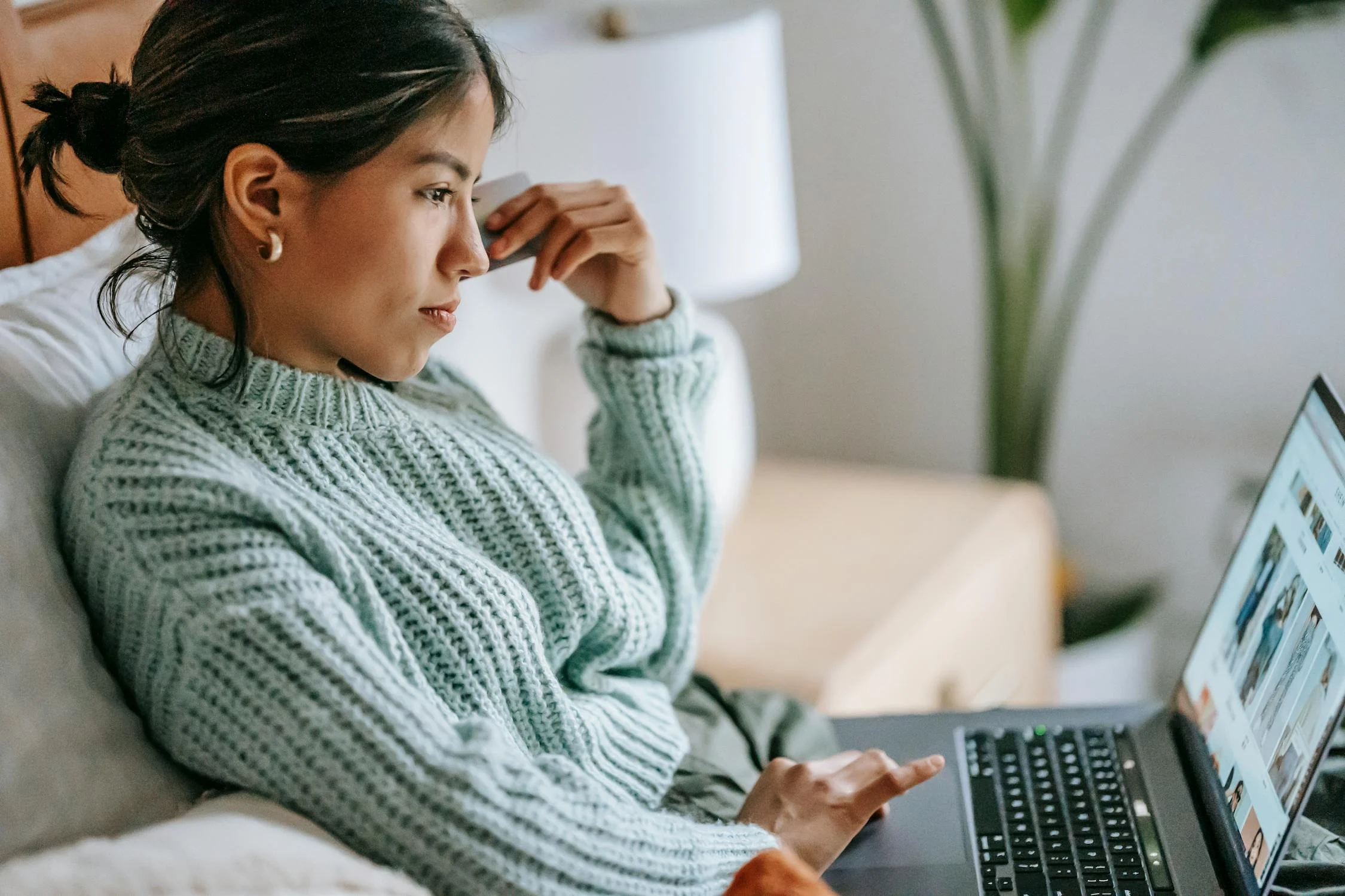 young woman with credit card and laptop