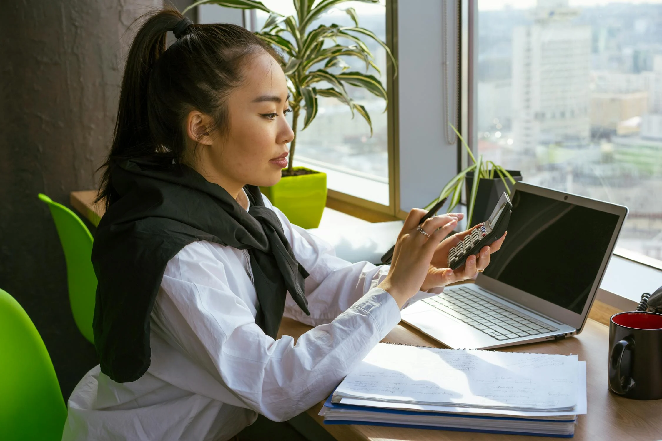 woman computing with a calculator