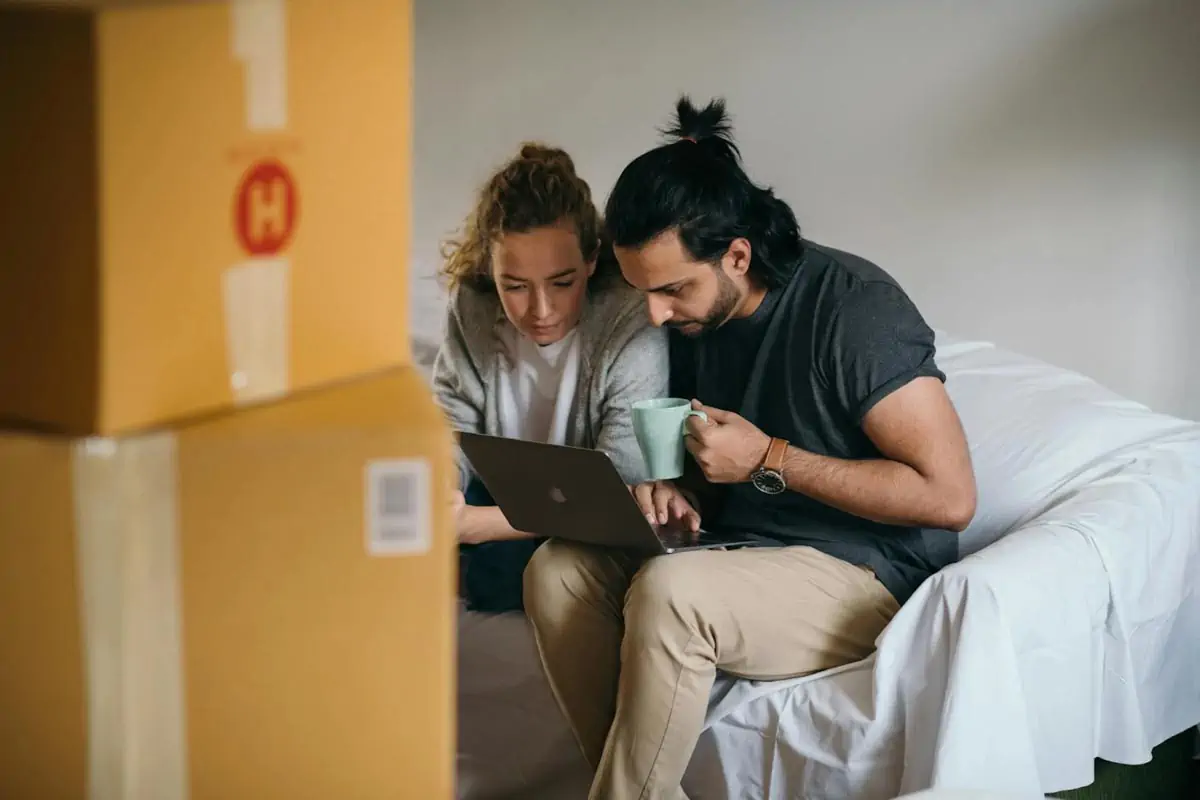 young multiethnic couple watching laptop