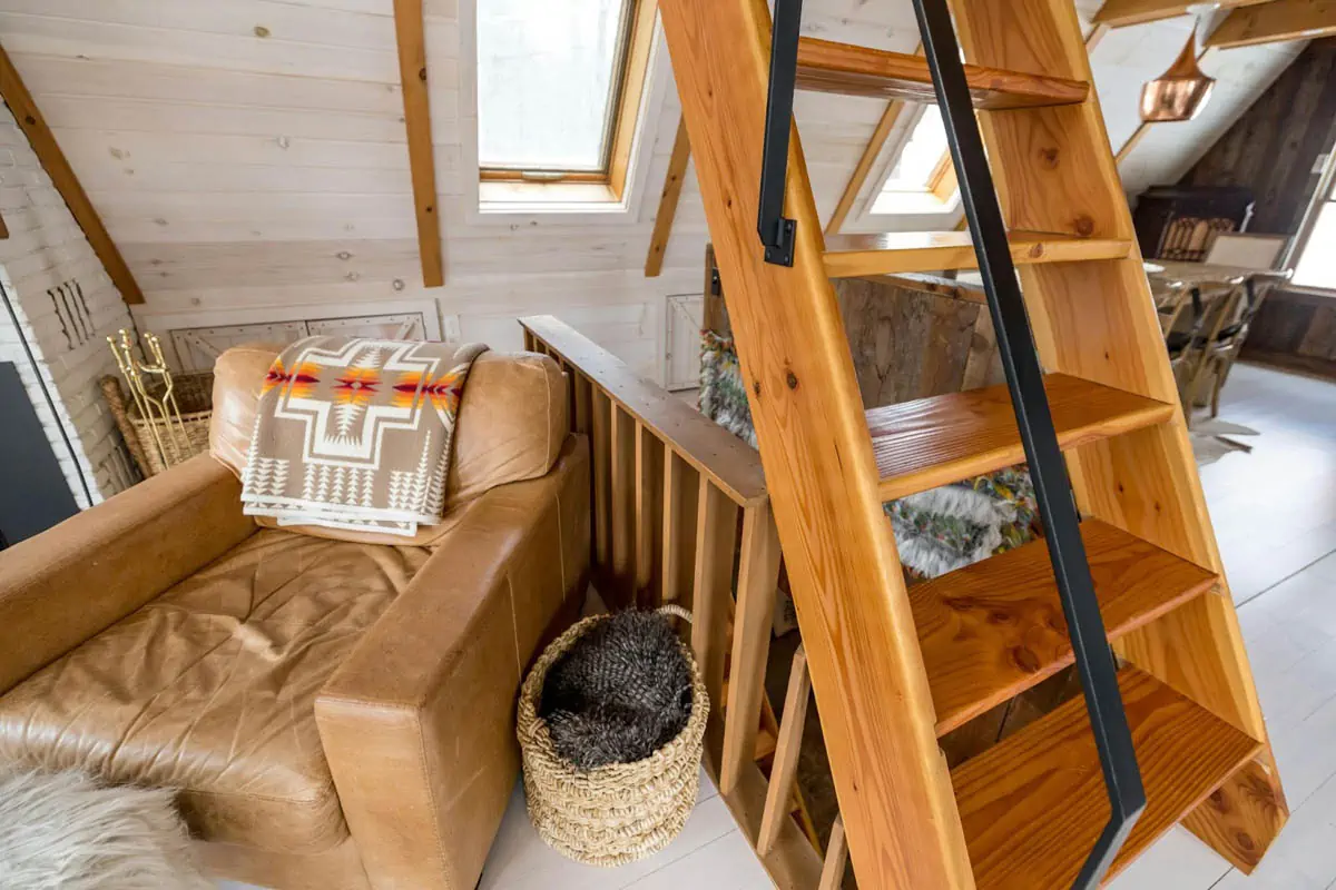 brown wooden staircase with brown and black pet bed