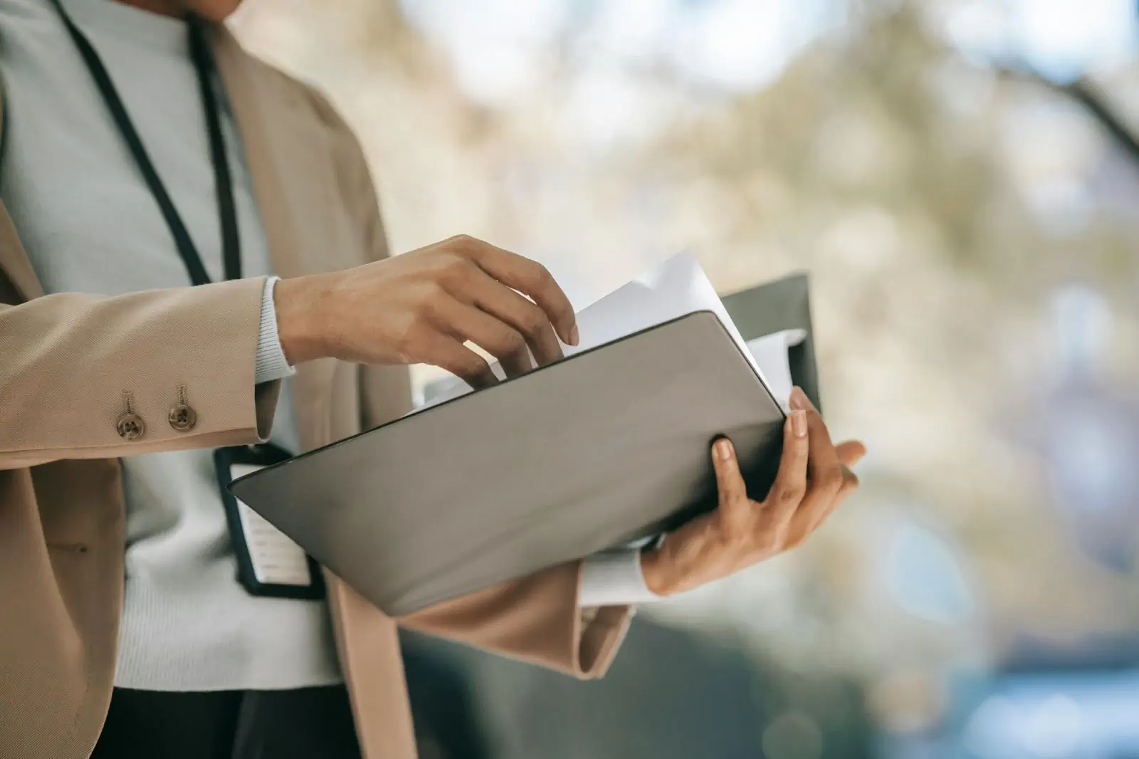 crop-businesswoman-with-folder-with-documents