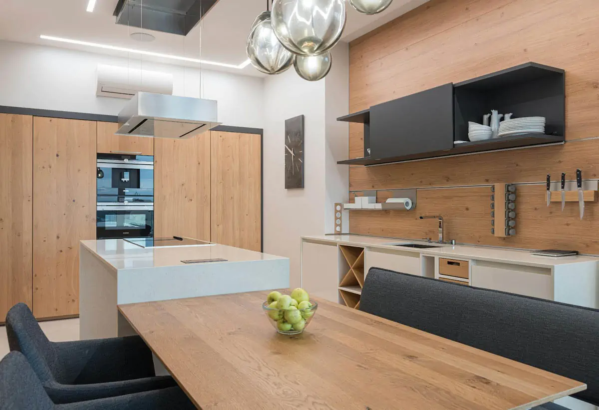 modern kitchen with black cupboard and brown table