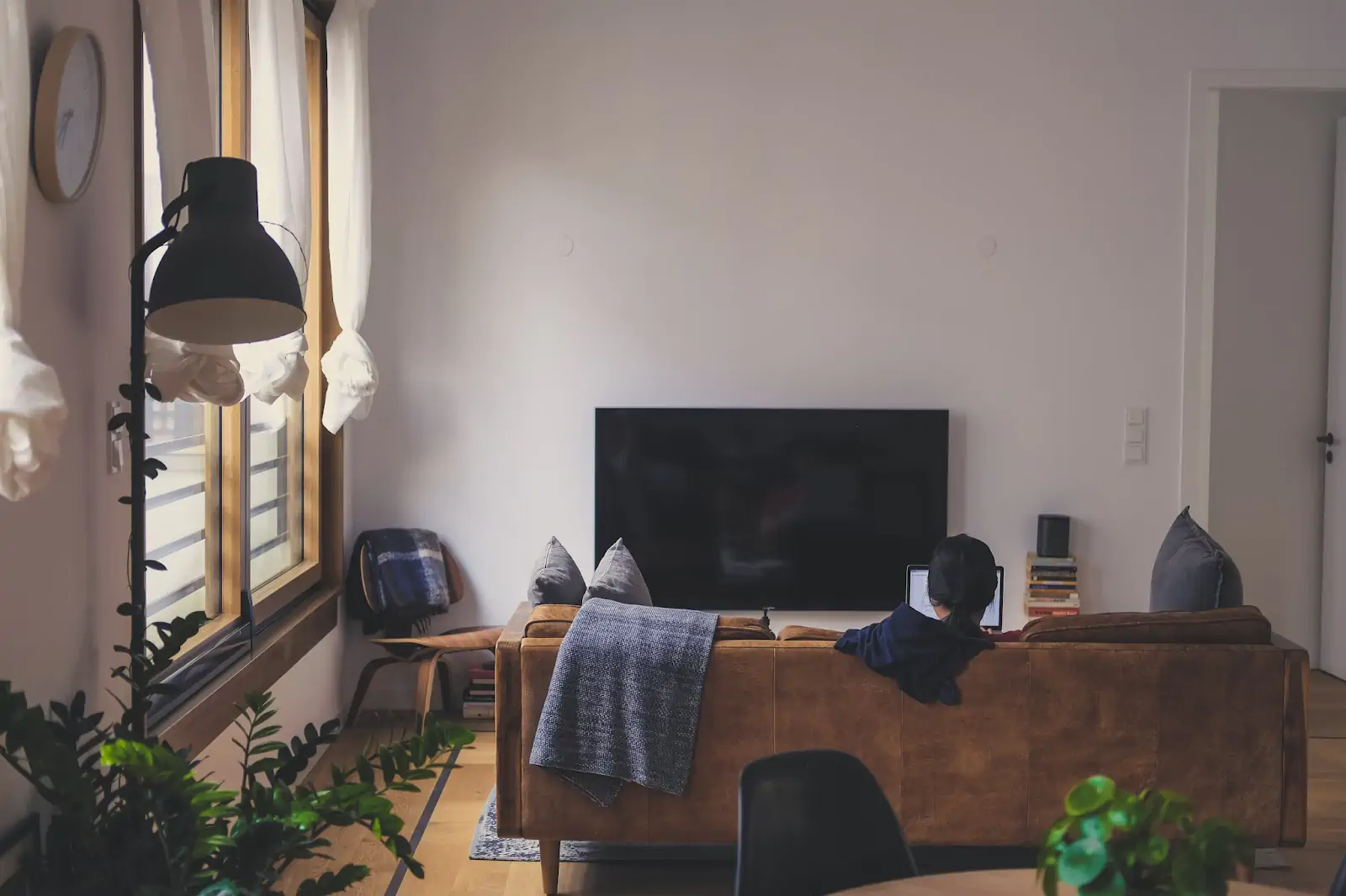 woman-sitting-on-couch-in-front-of-led-tv