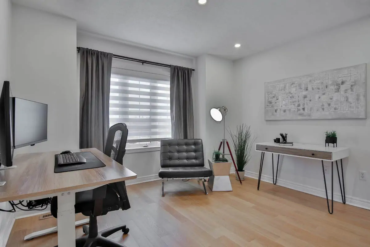 a-home-office-with-a-desk-chair-and-computer