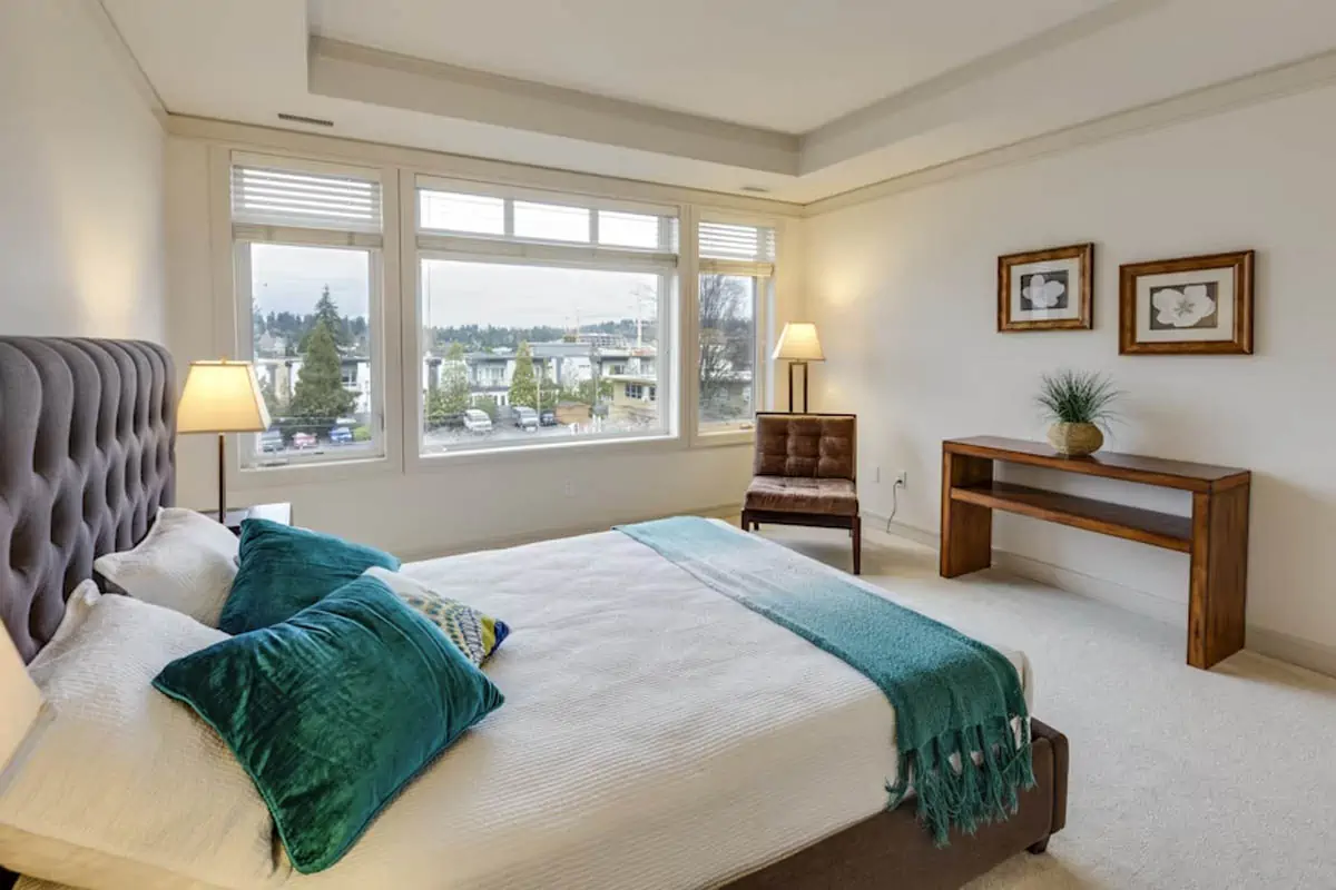 two-green-and-white-pillows-on-empty-bed