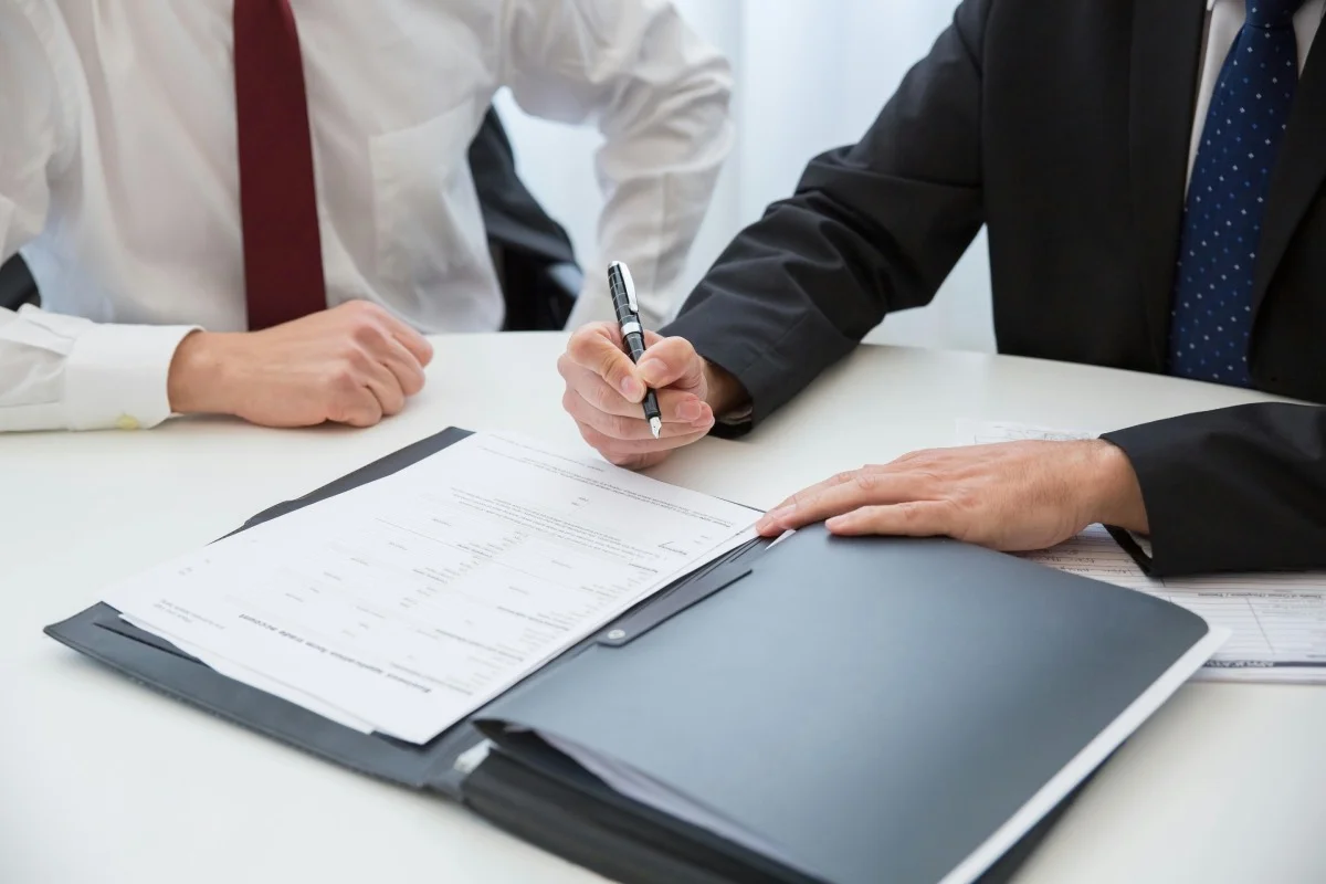 a-person-in-black-suit-holding-a-pen