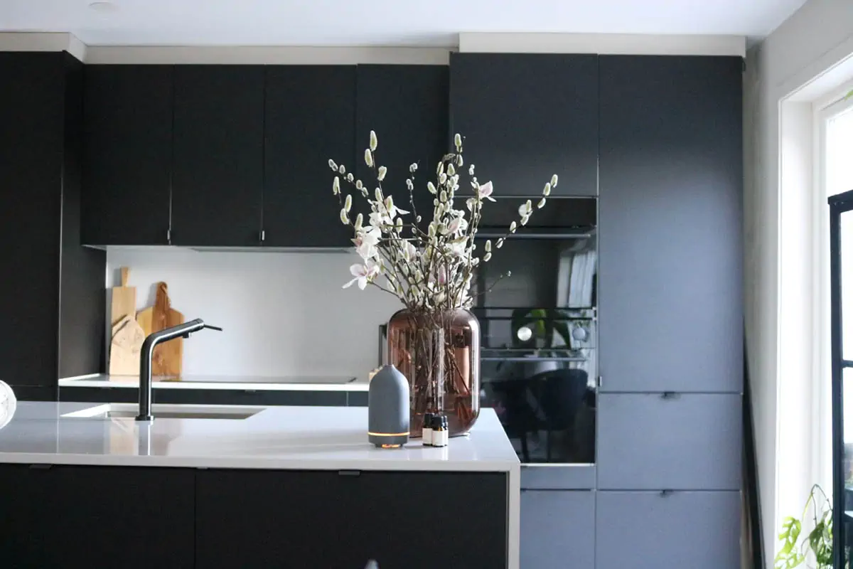 a-vase-of-flowers-sitting-on-a-kitchen-counter