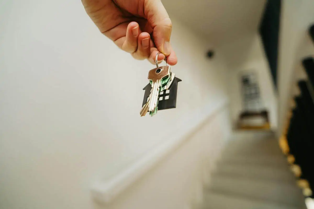 hand-holding-house-keychain-symbolizing-real-estate