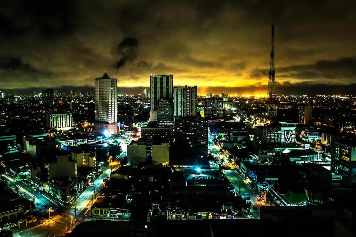 landscape-painting-of-high-rise-building-under-brown-sky