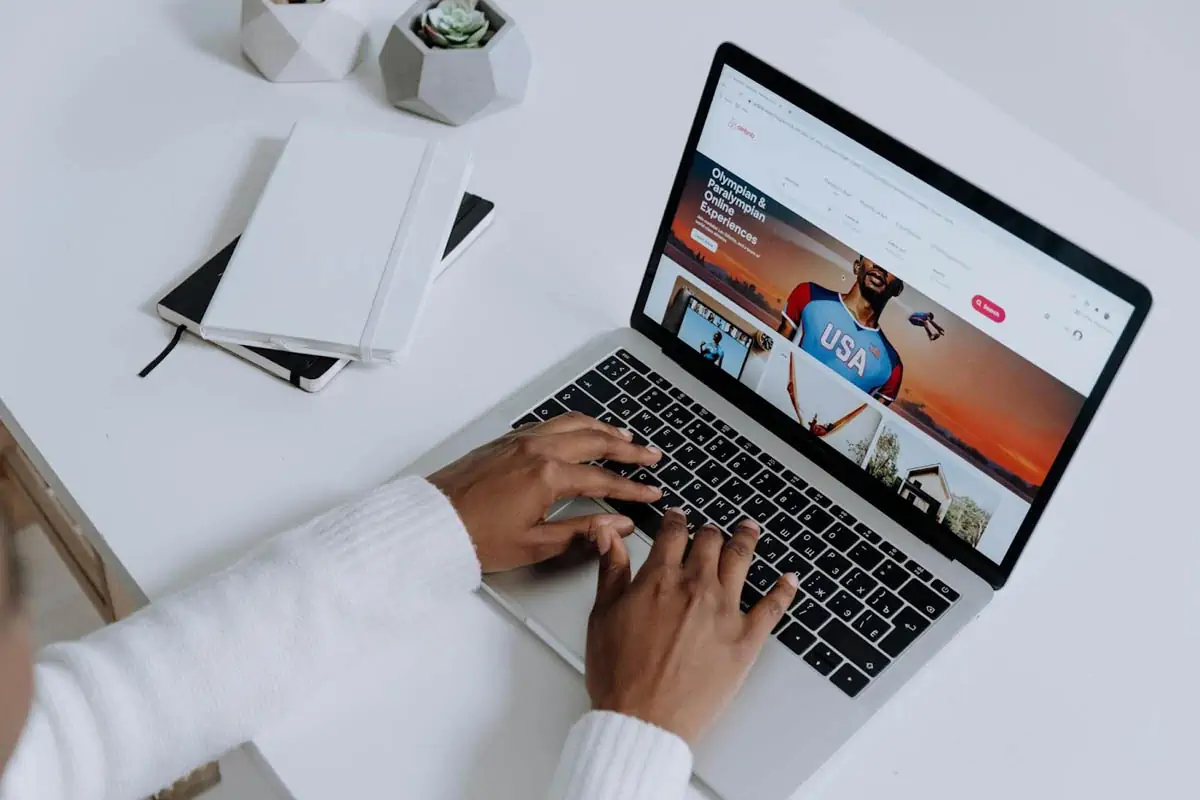 person-using-a-macbook-pro-on-a-white-table