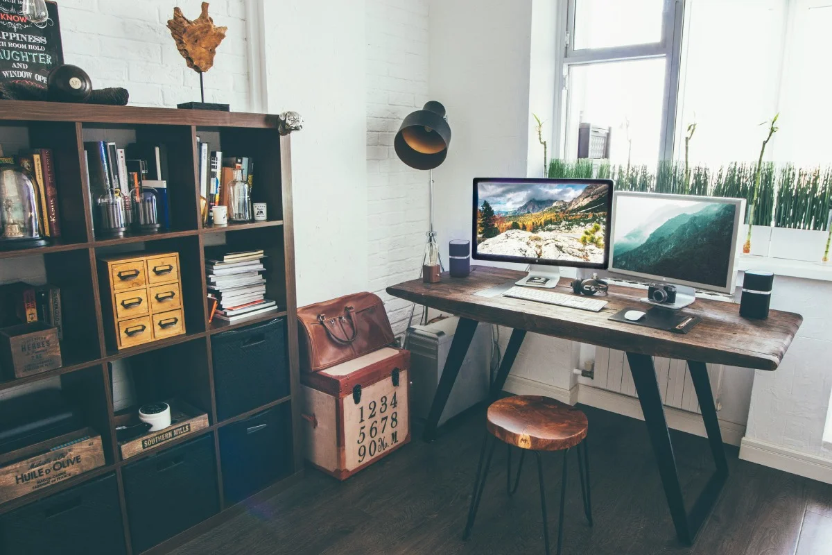 two-flat-screen-monitor-turned-on-near-organizer-rack