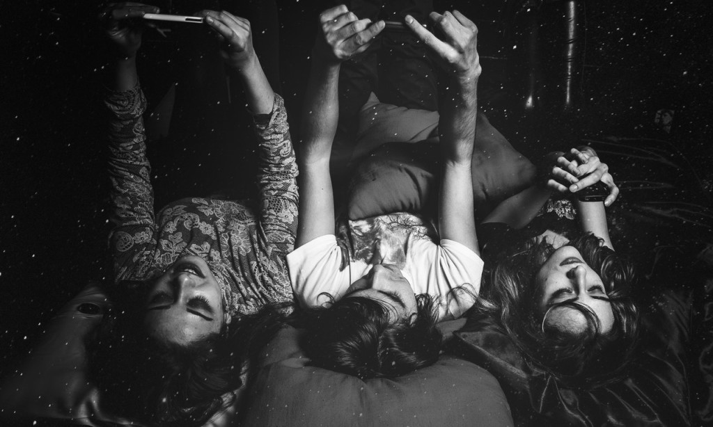 friends on bed with phone