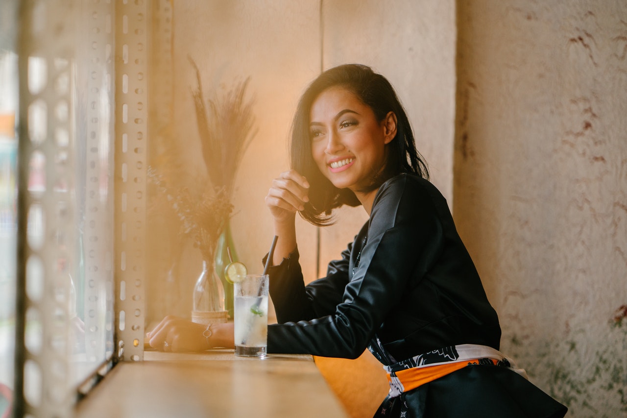 millennial sitting beside table