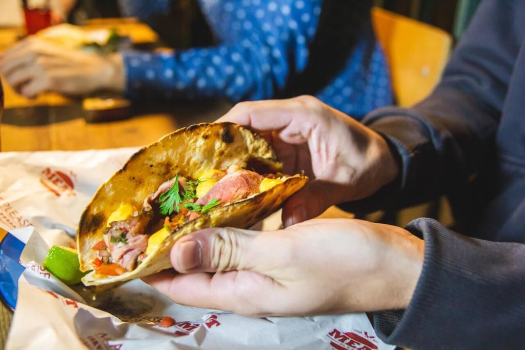 person showing taco with scrambled egg