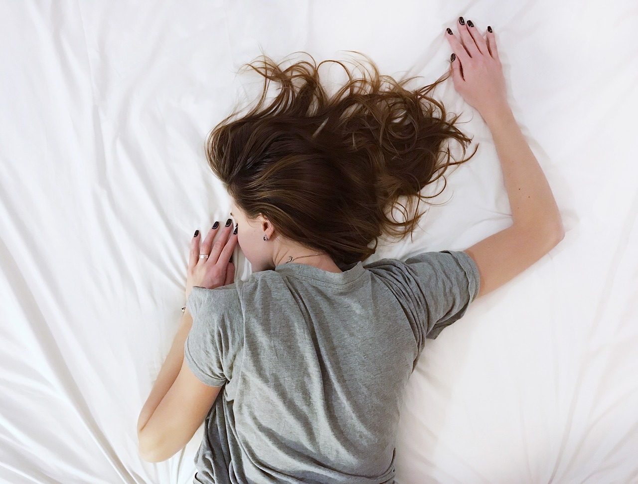 white bed sheet girl lying