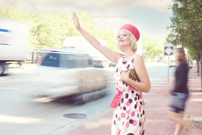 woman calling taxi on the street